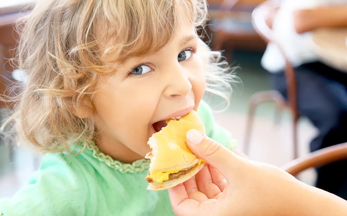 child eating burger